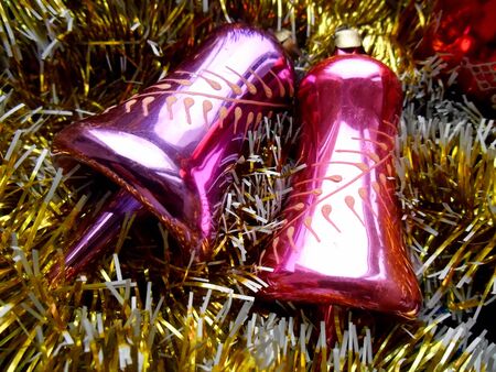 Christmas and New Year decoration bells on a golden backgroundの写真素材