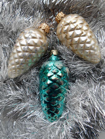 Christmas and New Year decoration with pine cones on a background of silver tinselの写真素材