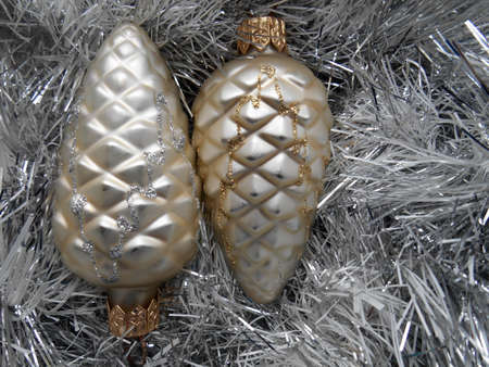 Christmas and New Year decoration with pine cones on a background of silver tinselの写真素材