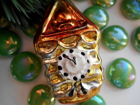 Christmas and New Year decoration golden clock and green stonesの写真素材