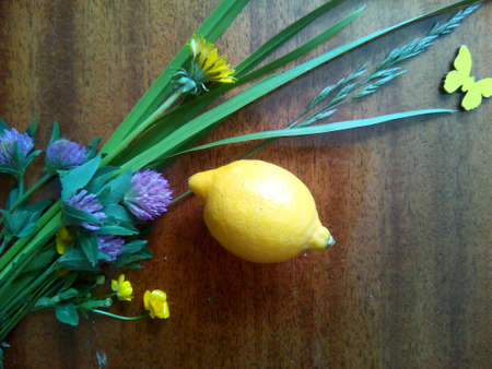 Summer flowers and lemon on the wooden beautiful の素材