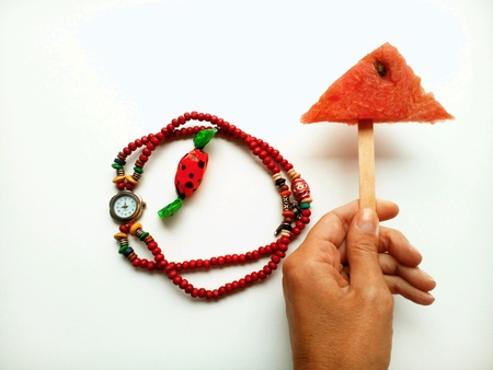 Watermelon,candy and beads on a white backgroundの素材