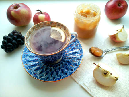Tea with honey and fruits on a white background