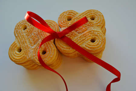Cookies sweet sugar and red ribbon on a white backgroundの写真素材
