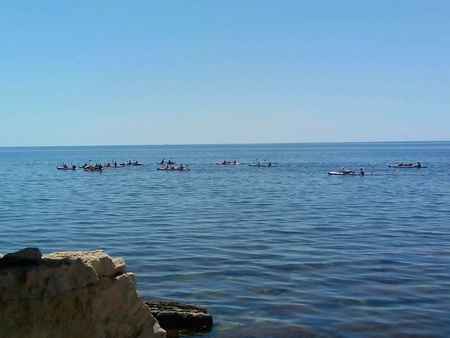 Peoples on the paddle boats in sea Crimea blue backgroundの素材