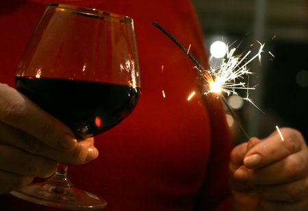 Bengal light and wine glass in female handの素材