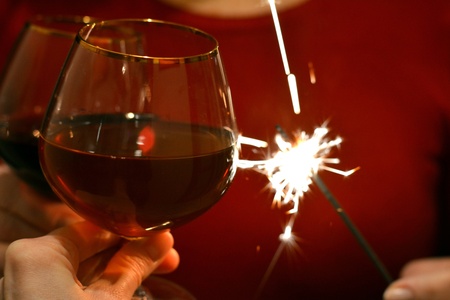 Clink wine glasses and bengal light in handsの素材