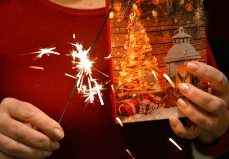 Christmas time gift and bengal light in the female handsの素材