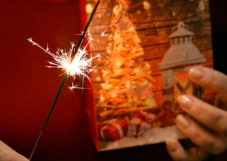 Christmas time gift and bengal light in the female handsの素材