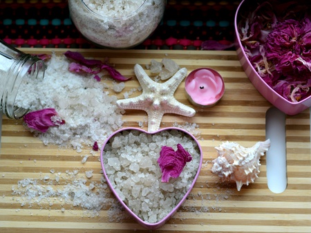 Spa sea salt bath heart and petals table backgroundの素材