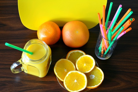 Orange juice and fruits on a wood backgroundの素材