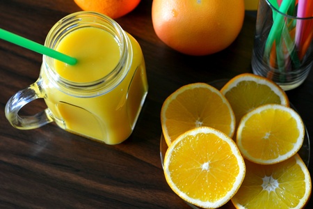Orange juice and fruits on a wood backgroundの素材