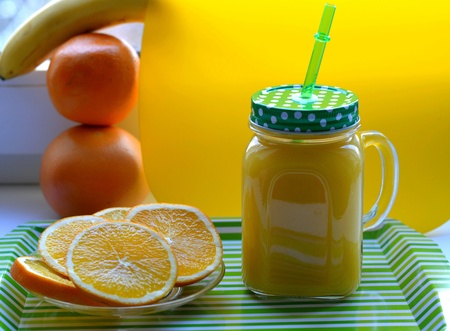 Orange juice and fruits yellow backgroundの素材