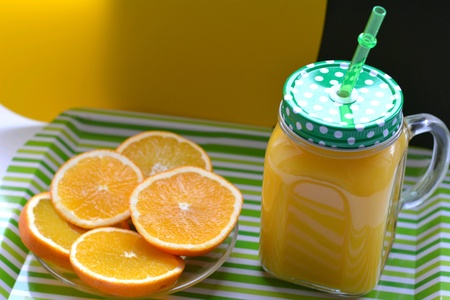 Orange juice and fruits green and yellow backgroundの素材