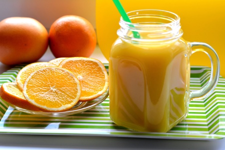 Orange juice and fruits green and yellow backgroundの素材