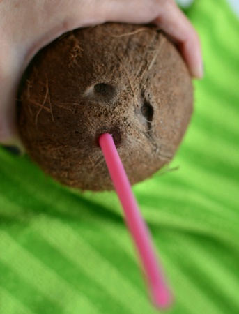 Coconut  cocktail in hand green backgroundの素材