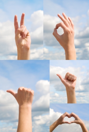 gesturing hands on a blue sky backgroundの写真素材