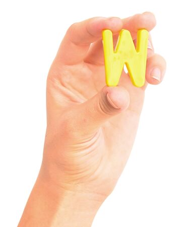 the letter W in a hand isolated on white backgroundの写真素材
