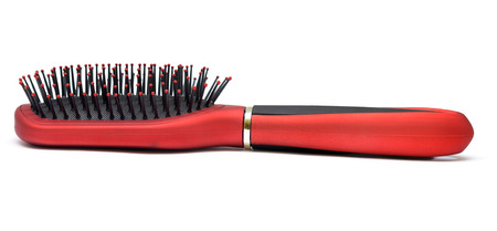 One red massages comb on white backgroundの写真素材