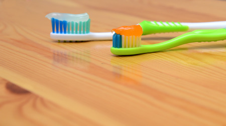 toothbrush with toothpaste on a wooden background