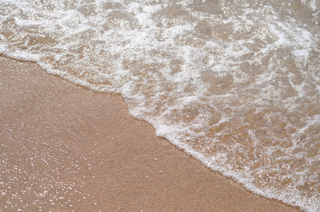 wave of blue ocean on sandy beach