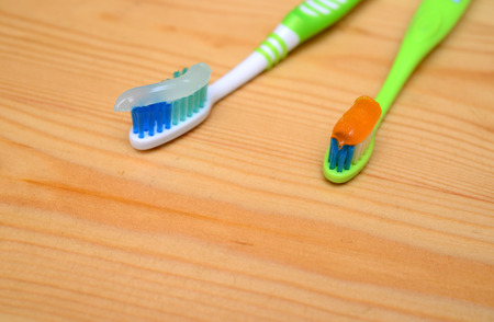 toothbrush with toothpaste on a wooden background