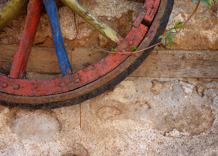 old wheel on a background of a stone wallの写真素材
