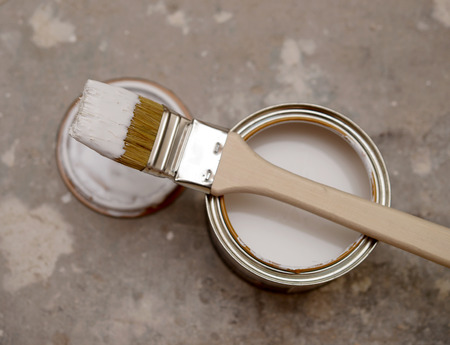 brush and bank of white paintの写真素材