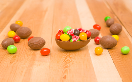 Easter chocolate eggs on a wooden backgroundの写真素材
