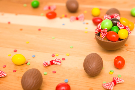 Easter chocolate eggs on a wooden backgroundの写真素材
