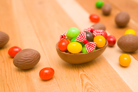 Easter chocolate eggs on a wooden backgroundの写真素材