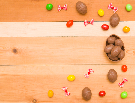 Easter chocolate eggs on a wooden backgroundの写真素材