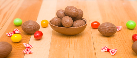 Easter chocolate eggs on a wooden backgroundの写真素材