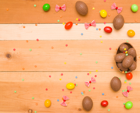 Easter chocolate eggs on a wooden backgroundの写真素材