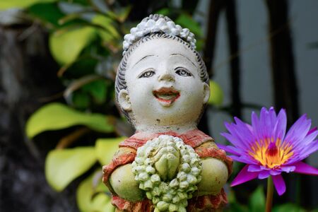 Statue Thai style and Purple lotus   