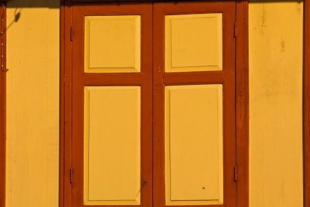 brown wood door in orange background ,is closedの写真素材