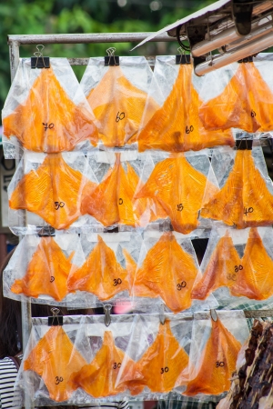 dried squid skewers a row for sale の写真素材