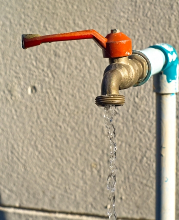 close up old water faucet left open の写真素材