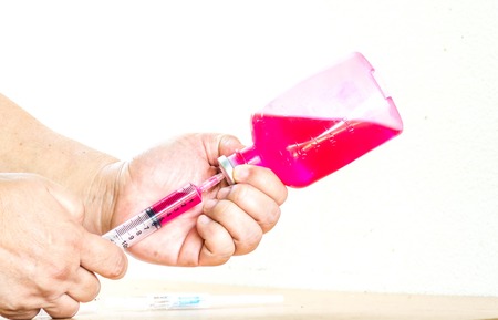 Syringe full of medicine, liquid in  bottle,redの写真素材