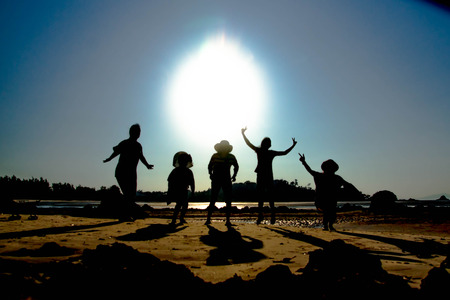 silhouette  of the sea ,Five women are jumpingの写真素材