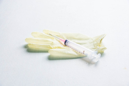 Surgical gloves and syringes used are contaminated with germs.の写真素材