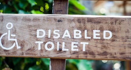 old wooden sign for disabled toilet ,copy spaceの写真素材