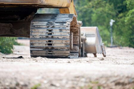 The wheel of a backhoe. Dirty wheel of a backhoe. in the construction site