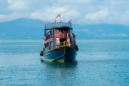 boat in the sea against the backdrop of mountainsの写真素材