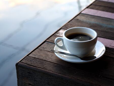 Coffee cup with spoon on the old wood tableの写真素材