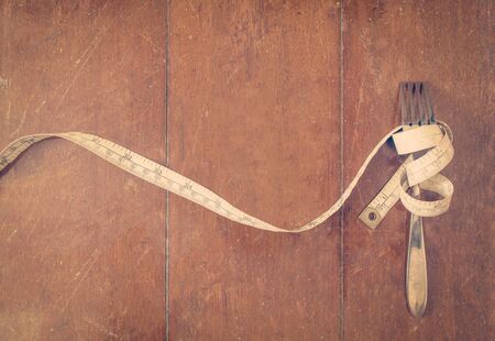 Measure tape with fork Diet concep filtered imageの写真素材