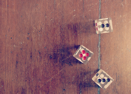 dices on wooden table vintage color tone abstract background to risk management concept.の写真素材