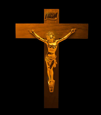 Gold Jesus Christ on the Cross with a Crown of Thorns Jesus of Nazareth King of the Jews Statue on the black backgroundの写真素材