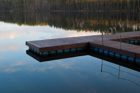 Boardwalk at the lake. Still waterの写真素材