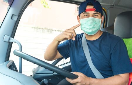 Close-up photos of Asian truck drivers wearing masks to protect against dust and the spread of the...